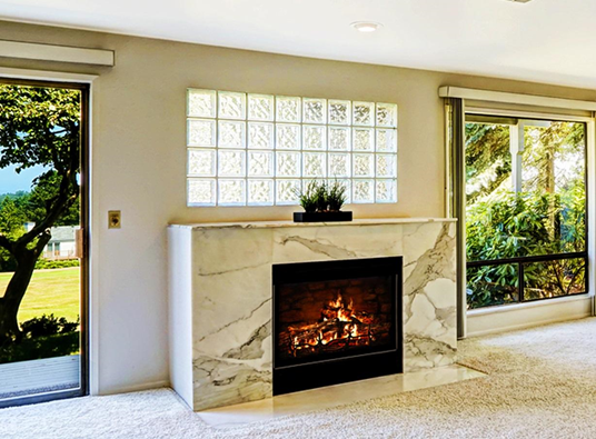 glass block window above marble fireplace