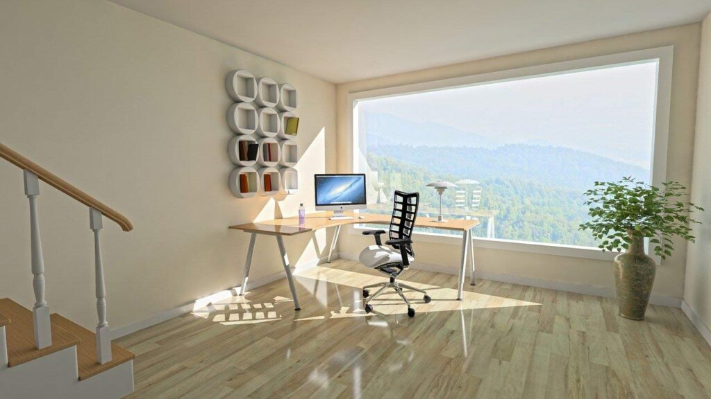 working from home office desk with window overlooking mountain landscape