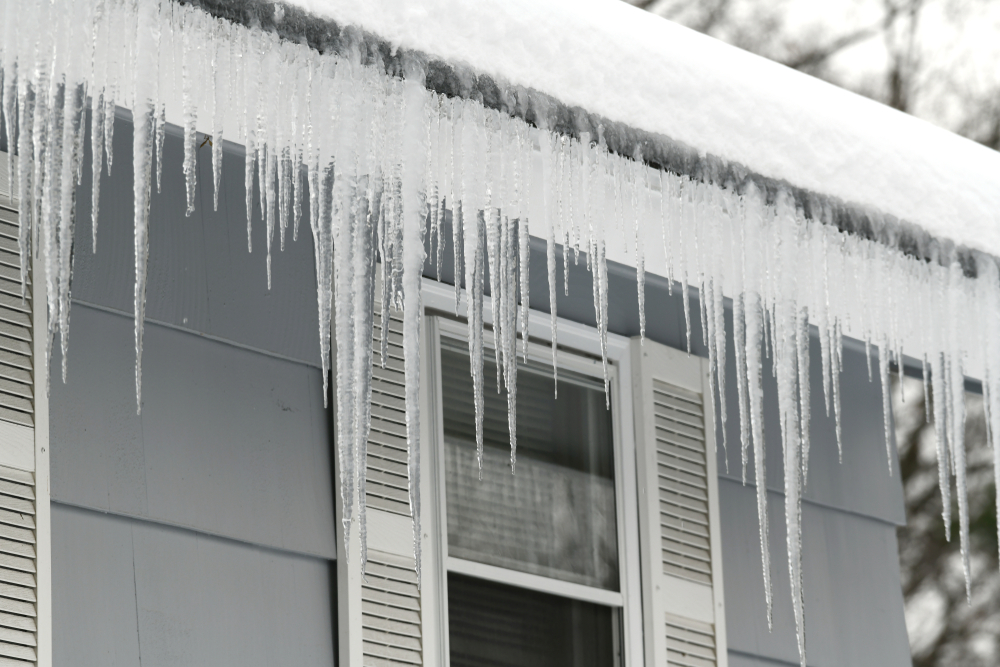 ice dams and icicles on edge of roof
