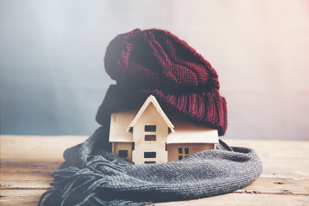 house model with hat and scarf, warm home during fall concept