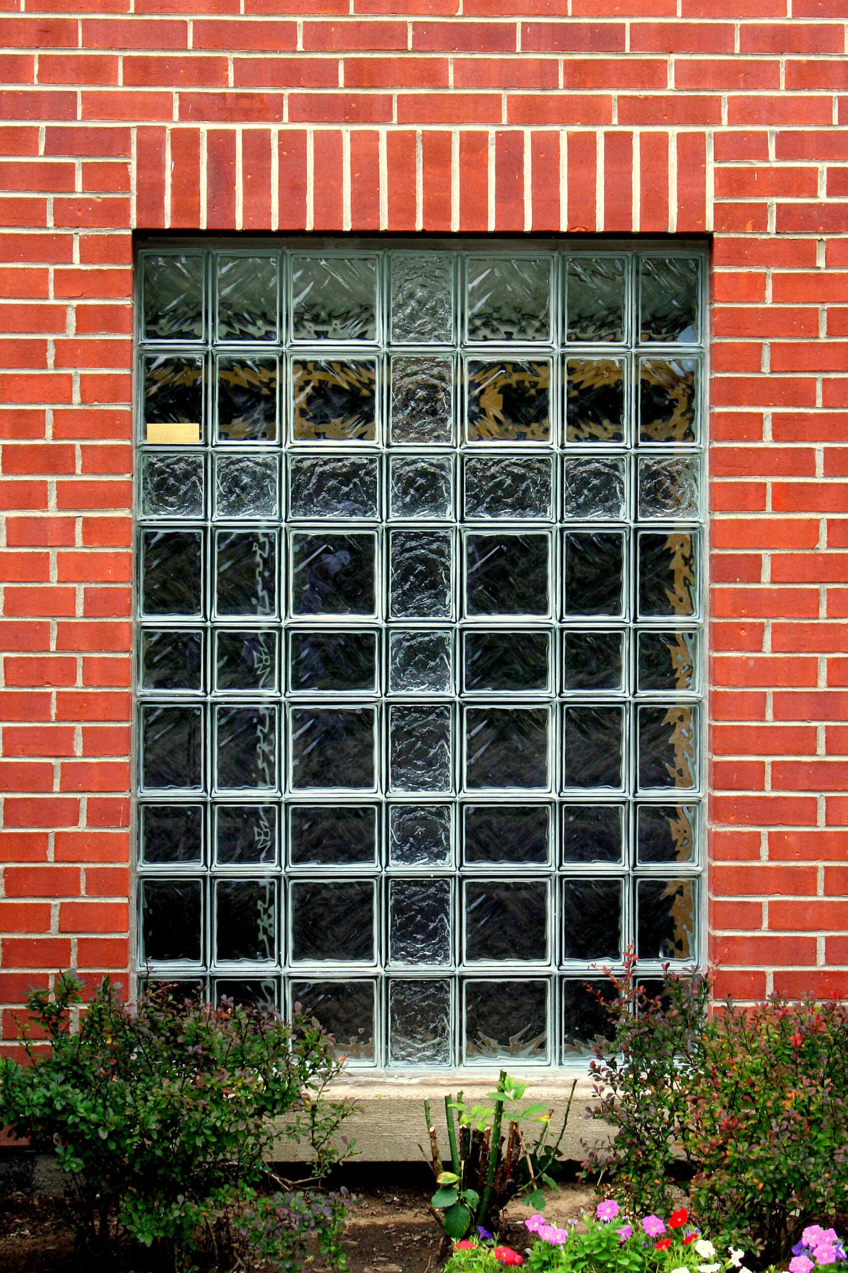 Exterior of glass block window on a Church with a Cross in it