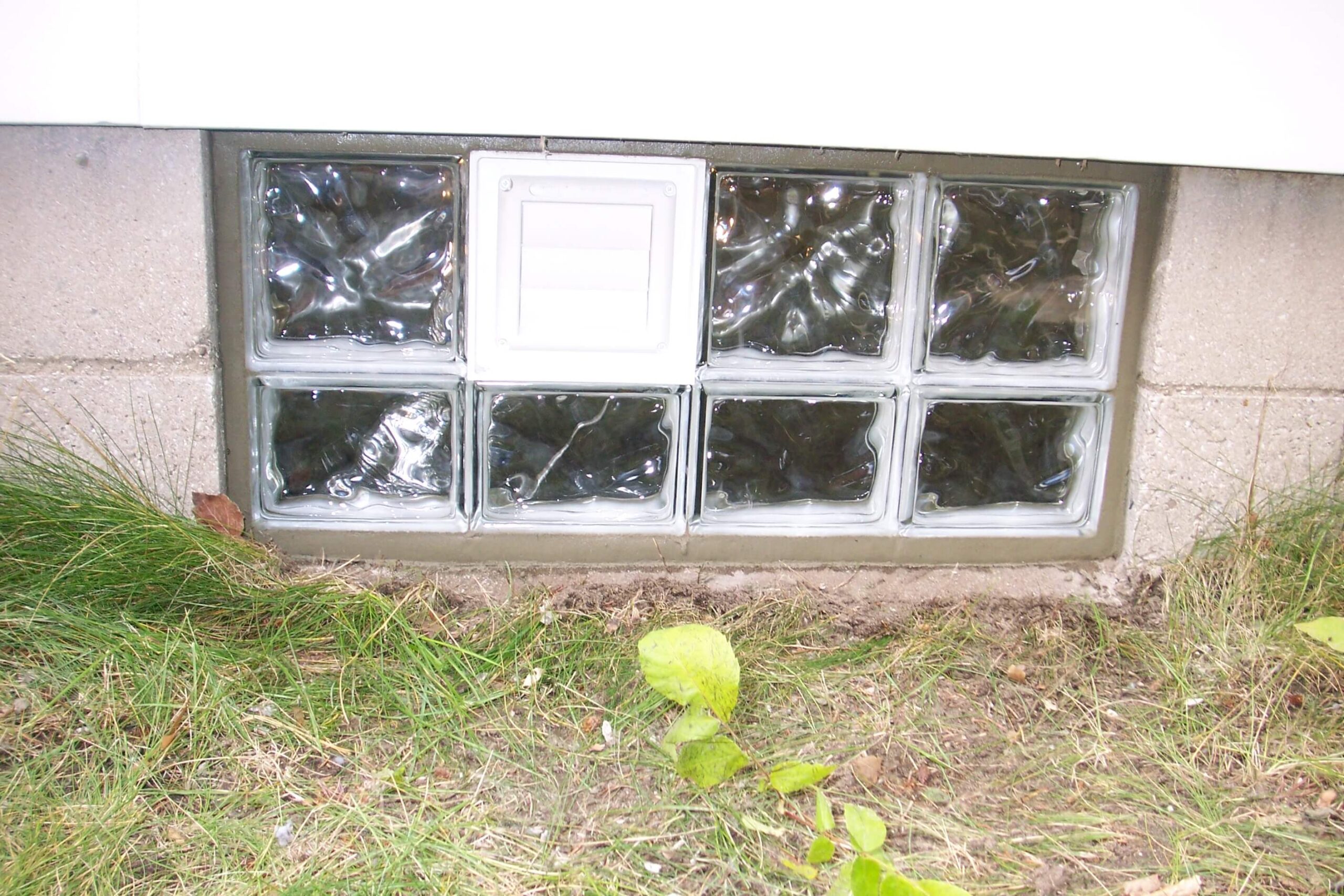 Glass block basement window with a dryer vent